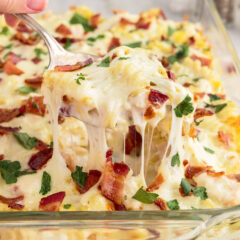 Spoonful of Chicken Bacon Ranch Casserole being lifted out of a casserole dish