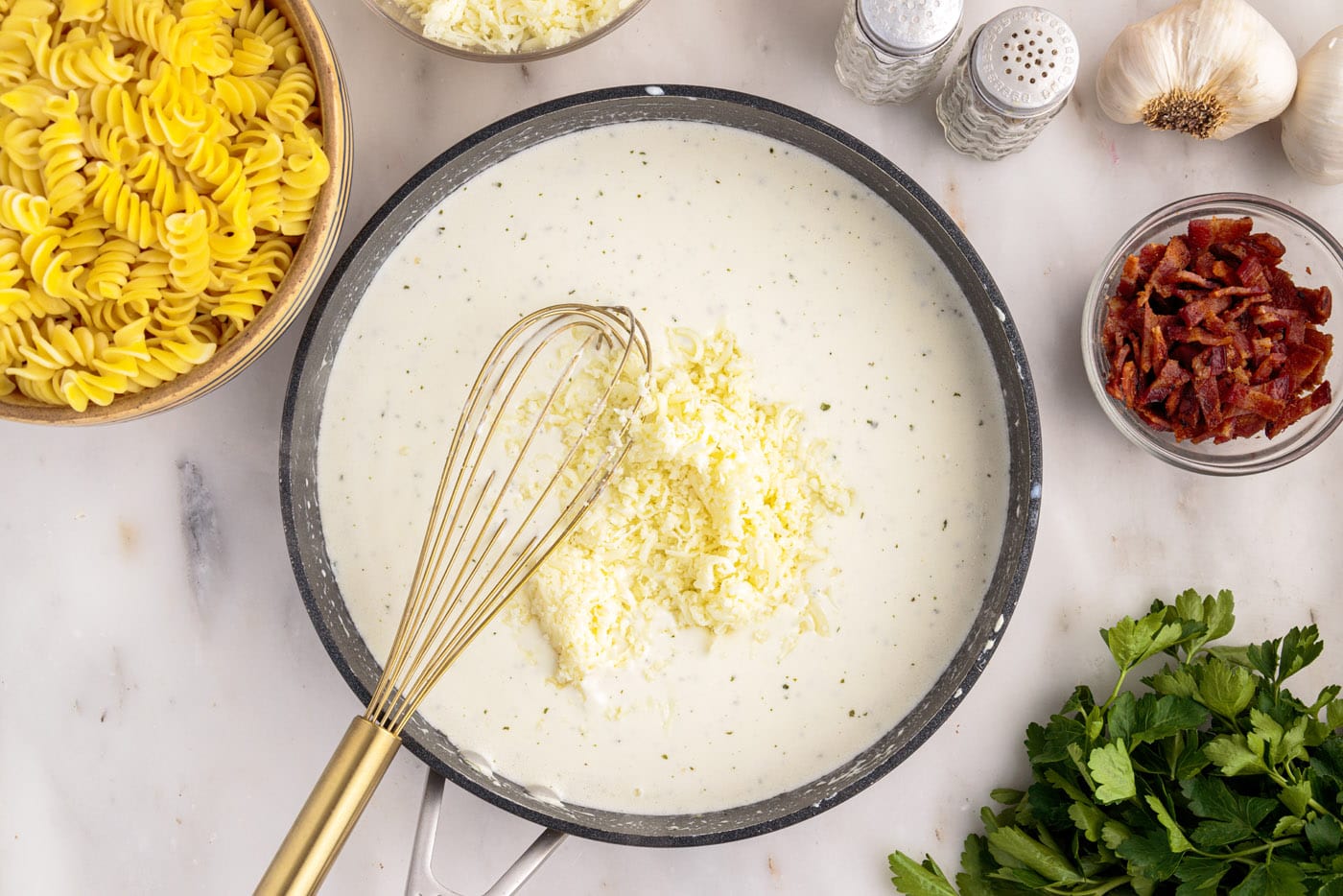 whisking cheese into cream cheese mixture in a skillet