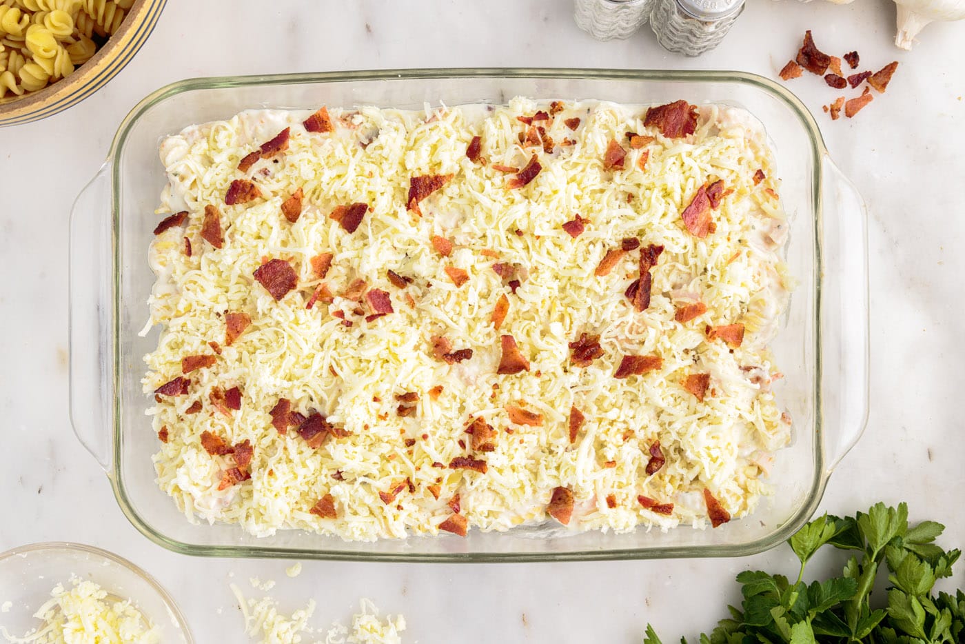 crumbled bacon on top of cream cheese and chicken pasta casserole