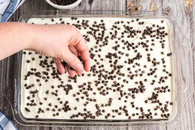 adding mini chocolate chips over whipped topping