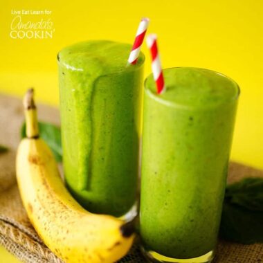 two green smoothies with straws