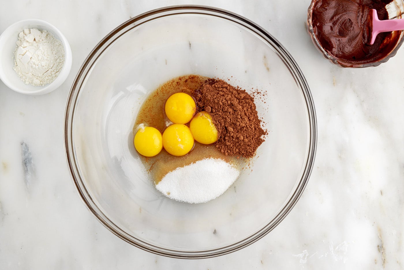 eggs, cocoa powder, vanilla, and sugar in a bowl