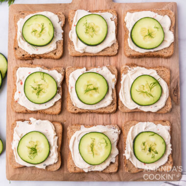 wood board of cucumber sandwiches